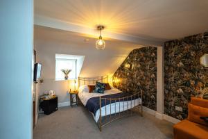 a bedroom with a bed and a wall mural at Channel View Guest House in Weymouth