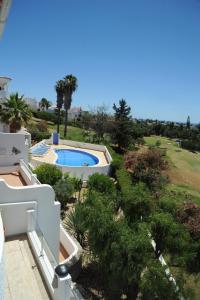 an aerial view of a villa with a swimming pool at Renovated Vale do Milho Golf Apartment with sea view in Carvoeiro