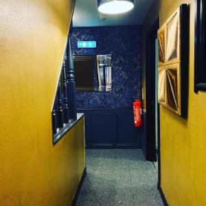 a hallway of a room with a yellow wall at The Old Mill Inn in Forres