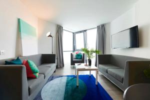 a living room with two couches and a tv at Chic Apartments and Private Bedrooms at Beckett House near Dublin City Centre in Dublin