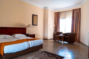 A bed or beds in a room at Swiss Inn Plaza Hotel