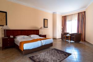 A bed or beds in a room at Swiss Inn Plaza Hotel