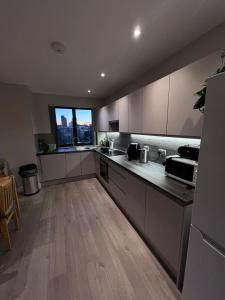 a large kitchen with a large window in it at Deluxe central London in London