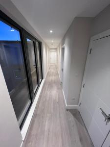 an empty hallway with wood floors and large windows at Deluxe central London in London