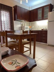 uma cozinha com uma mesa e um frigorífico em MP house em Kallithea Halkidikis