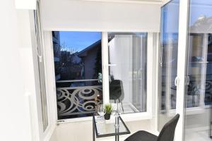 a large window with a view of a balcony at Lux Spa Apartman na Vračaru in Vračar (historical)