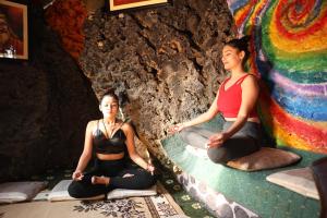 two women sitting in meditation in a cave at Rock Garden Resort in Pokhara