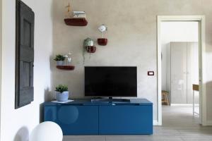 a blue cabinet in a living room with a tv at La Casa Di Cele in Desenzano del Garda