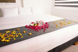 a bed with a bunch of flowers on it at Hotel Montefiore in Bogotá