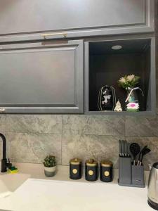 a kitchen counter top with a sink and a cabinet at luxury apartment - Prince majed park in Jeddah