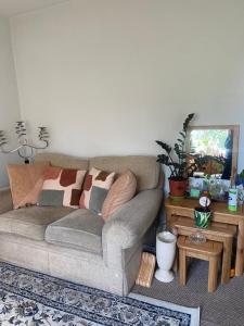 a living room with a couch and a table at Cozy home in Croydon