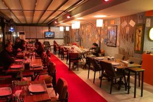 a restaurant with people sitting at tables in a room at Arya Apart Kundu Hotel in Lara