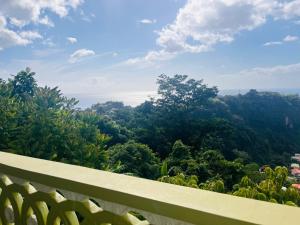 a view of a forest from a balcony at City View Accommodations in Roseau