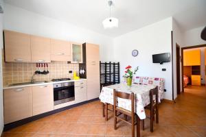 a kitchen with a table and chairs in a room at Piccolo Residence Gallipoli in Gallipoli +32 photos