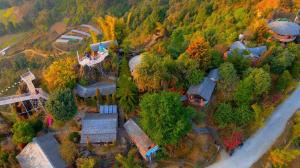 an overhead view of a house with trees and a road at Rock Garden Resort in Pokhara