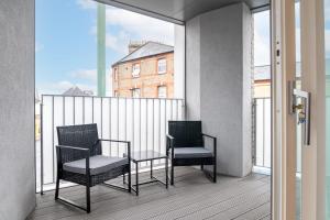 two chairs and a table on a balcony at GuestReady - Lovely Home in Fulham in London