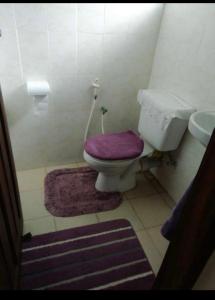 a bathroom with a purple toilet and a sink at ZURI Homestay WIFI & Ocean BREEZE !! in Mombasa