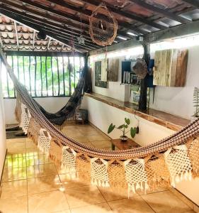 a hammock in the middle of a room at Hostel Terra Viva in Pipa