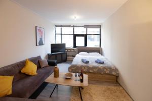 a living room with a bed and a couch at κέντρο πόλης Βασίλης in Ioannina