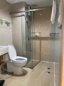 a bathroom with a toilet and a glass shower at L18 residence in Ban Zong Katiam +37 photos