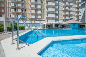a swimming pool in front of a apartment building at Residence Playa Grande Immobiliare Pacella in Lido di Jesolo +128 photos