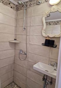 a bathroom with a shower and a sink at Casa di Syrii in Ermoupoli