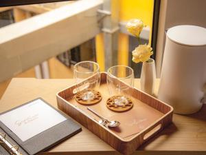 un vassoio di legno con due bicchieri su un tavolo di Belive&More a Macao
