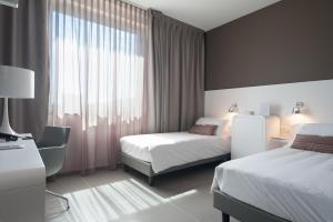 Postel nebo postele na pokoji v ubytování 8Piuhotel