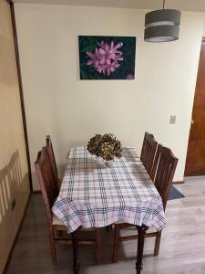 a dining room table with a plaid table cloth and chairs at DEPARTAMENTO 2 EN PLENO CENTRO DE PUERTO MONTT in Puerto Montt