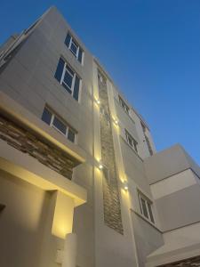 a building with lights on the side of it at Al Qalah flats 