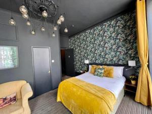 a bedroom with a yellow bed and a chair at LuXe Apartments Kemptown in Brighton & Hove