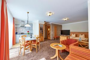 フロンハイムにあるLandhotel im Klostereck Strubel-Roosのリビングルーム、キッチン(テーブル、ソファ付)