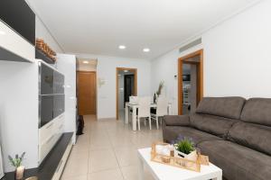 a living room with a couch and a table at Veramar Beach Apartment in Valencia