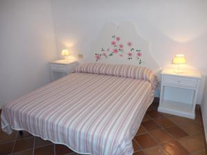 ein kleines Schlafzimmer mit einem Bett mit zwei Nachttischen in der Unterkunft Azienda Il Tizzano in Albinia