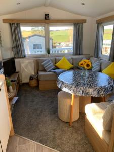 a living room with a couch and a table at Newquay Bay in Newquay