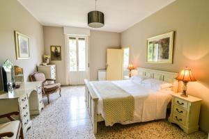 a bedroom with a bed and a desk and a chair at Villa Ariola in Villafranca in Lunigiana