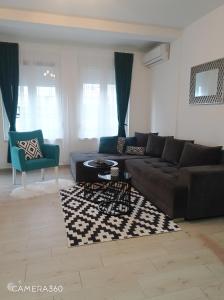 a living room with a couch and a table at Apartman SILVER in Sremska Mitrovica