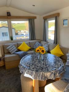 a living room with a couch and a table at Newquay Bay in Newquay