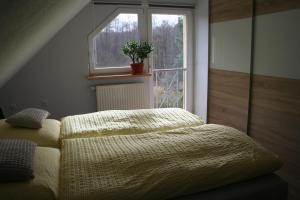 a bedroom with a bed in front of a window at Ferienhaus Helbig Buckow in Buckow