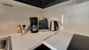 a white counter top with a coffee maker on it at Konnet Apartment in Rhodes Town