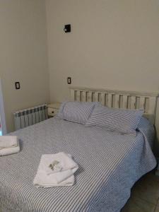 ein Schlafzimmer mit 2 Betten und Handtüchern darauf in der Unterkunft Ojo de Agua Villa La Angostura in Villa La Angostura