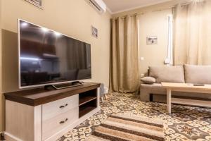 a living room with a large flat screen tv at Goutadika in Limenas +20 photos