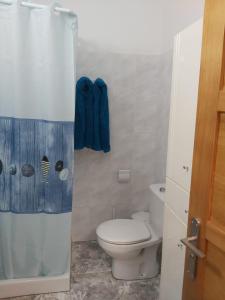 een badkamer met een toilet en een douche bij Ajuy apartament Seafront&quiet in Ajuy