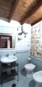 a bathroom with two sinks and a toilet at Palazzo Saraceno apartments-Antico Rifugio in Taranto