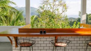 a bar with a view of the mountains at Fairy Cottage Kandy in Kandy