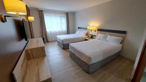 Postel nebo postele na pokoji v ubytování Hotel Diego de Almagro Castro