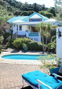 a house with a swimming pool in front of a house at Mont Fleur B&B in Wilderness