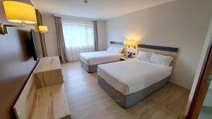 Postel nebo postele na pokoji v ubytování Hotel Diego de Almagro Castro