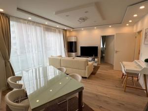a living room with a couch and a table at Lovely HOME Suite in Nuremberg in Nürnberg