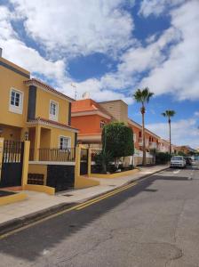 a street with houses and a car parked on the street at Pendhous Sabina mit Jacuzzi in Callao Salvaje